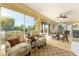 Sunroom with large windows, tile floors, and comfortable seating for entertaining at 1446 Arbor Trl, The Villages, FL 32162