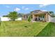 A well-maintained backyard featuring green grass, patio, grill and partial fence, ideal for outdoor enjoyment at 15322 Veramonte Way, Orlando, FL 32828