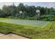 An outdoor basketball court in the community surrounded by green space and mature trees at 15322 Veramonte Way, Orlando, FL 32828