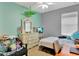 The cozy bedroom includes a plush chair, a large dresser, and a ceiling fan at 15322 Veramonte Way, Orlando, FL 32828