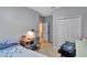 Neutral bedroom includes a writing desk, closet and a chair at 15322 Veramonte Way, Orlando, FL 32828