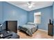This bedroom is a calm blue color and has a dresser and wood floor at 15322 Veramonte Way, Orlando, FL 32828