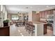 Spacious open-plan kitchen flowing into the living area, featuring a breakfast bar and modern appliances at 15322 Veramonte Way, Orlando, FL 32828
