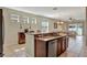 Modern kitchen featuring a granite-topped island, stainless steel appliances, and dark wood cabinetry at 15322 Veramonte Way, Orlando, FL 32828