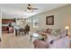 Inviting living room with neutral tones, tile flooring, and comfortable seating, perfect for relaxation and entertaining at 15322 Veramonte Way, Orlando, FL 32828