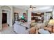 Open-concept living area with tile floors, seamlessly connecting the living room, dining area, and kitchen at 15322 Veramonte Way, Orlando, FL 32828