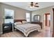 Comfortable main bedroom boasts wood floors, bright windows, and an attractive dresser at 15322 Veramonte Way, Orlando, FL 32828