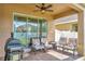 Covered patio features brick flooring, ceiling fan, and comfortable seating, perfect for entertaining at 15322 Veramonte Way, Orlando, FL 32828