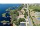 Breathtaking aerial view of a waterfront community with a road winding along the serene lakefront property at 16211 Oak Breeze Ct, Clermont, FL 34711