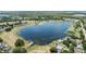Bird's eye view of a lake in a beautiful lakeside community with many homes at 16211 Oak Breeze Ct, Clermont, FL 34711