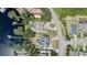 Birds eye view of a house near a lake with docks and neighborhood at 16211 Oak Breeze Ct, Clermont, FL 34711