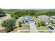 Aerial view of the home showcasing the lush landscaping, well-maintained lawn, and neighborhood at 16211 Oak Breeze Ct, Clermont, FL 34711