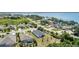 Beautiful aerial view of homes with a pool along a picturesque lake, showcasing waterfront living and community charm at 16211 Oak Breeze Ct, Clermont, FL 34711