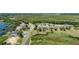 Panoramic aerial of waterfront homes, lush greenery, and docks along a tranquil lakefront, highlighting community charm at 16211 Oak Breeze Ct, Clermont, FL 34711