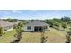 View of the home's exterior with a screened porch, overlooking a freshly mowed lawn at 16211 Oak Breeze Ct, Clermont, FL 34711