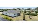 Aerial view of the home's backyard and screened porch overlooking the freshly mowed lawn at 16211 Oak Breeze Ct, Clermont, FL 34711