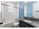 Stylish bathroom featuring a granite vanity, modern fixtures, and a shower-tub combo for relaxation at 16211 Oak Breeze Ct, Clermont, FL 34711
