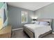 Comfortable bedroom with natural light, a decorative accent wall, and a serene atmosphere at 16211 Oak Breeze Ct, Clermont, FL 34711