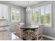 Bright breakfast nook with modern lighting, large windows and plantation shutters at 16211 Oak Breeze Ct, Clermont, FL 34711