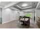 Open-concept dining room with stylish light fixtures and wood-look floors at 16211 Oak Breeze Ct, Clermont, FL 34711
