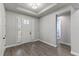 Entryway features wood-look flooring, white trim, and a front door with sidelights at 16211 Oak Breeze Ct, Clermont, FL 34711