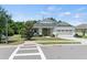 Charming single-story home boasts a well-manicured lawn, a two-car garage, and inviting curb appeal at 16211 Oak Breeze Ct, Clermont, FL 34711