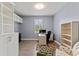 Bright home office with built-in shelves, ample workspace, and a comfortable seating area at 16211 Oak Breeze Ct, Clermont, FL 34711