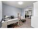 Spacious home office featuring a large desk, shelving, and a cozy seating area for a productive work environment at 16211 Oak Breeze Ct, Clermont, FL 34711