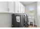 Well-equipped laundry room with modern washer and dryer, ample storage, and a convenient utility sink at 16211 Oak Breeze Ct, Clermont, FL 34711