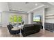 Open living room with wood floors, recessed lights, patio access, and sleek furnishings at 16211 Oak Breeze Ct, Clermont, FL 34711