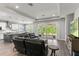 Open-concept living room with wood flooring, recessed lights, kitchen and sliding doors at 16211 Oak Breeze Ct, Clermont, FL 34711