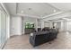 Spacious living room with wood floors, recessed lighting, and an open layout at 16211 Oak Breeze Ct, Clermont, FL 34711