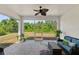 Relaxing screened porch with comfortable seating, a ceiling fan, and peaceful views of the backyard at 16211 Oak Breeze Ct, Clermont, FL 34711