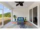 Inviting screened porch featuring stylish furniture, a ceiling fan, and serene outdoor views at 16211 Oak Breeze Ct, Clermont, FL 34711