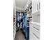Organized walk-in closet with ample shelving, cabinets, and hanging space for clothing and accessories at 16211 Oak Breeze Ct, Clermont, FL 34711