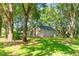 A spacious backyard, framed by lush trees, offers a serene outdoor retreat at 1663 Markel Dr. Dr, Winter Garden, FL 34787