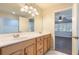 Bathroom features a dual vanity, a mirror and access to a bedroom at 1663 Markel Dr. Dr, Winter Garden, FL 34787