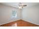 A minimalist bedroom has hardwood floors and a ceiling fan at 1663 Markel Dr. Dr, Winter Garden, FL 34787