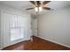 A minimalist bedroom features hardwood floors, a ceiling fan, and a closet at 1663 Markel Dr. Dr, Winter Garden, FL 34787