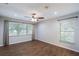 This airy bedroom features tile floors, large windows, a ceiling fan, and neutral walls at 1663 Markel Dr. Dr, Winter Garden, FL 34787