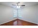 Bright bedroom featuring hardwood floors, a ceiling fan, and two windows with blinds for natural light at 1663 Markel Dr. Dr, Winter Garden, FL 34787