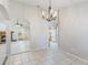 Dining area showcasing tile flooring with arched openings to living room with fireplace and kitchen with white appliances at 1663 Markel Dr. Dr, Winter Garden, FL 34787