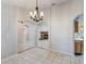 Open-concept dining area with tile floors and arched doorways leading to the living room and kitchen, creating a flow at 1663 Markel Dr. Dr, Winter Garden, FL 34787