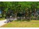 Exterior view of home surrounded by trees and a chain link fence at 1663 Markel Dr. Dr, Winter Garden, FL 34787