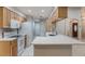 An open kitchen features an eat-in breakfast bar, modern appliances, and bright lighting at 1663 Markel Dr. Dr, Winter Garden, FL 34787