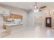 Inviting living space featuring a breakfast bar, tile flooring, and a view through an archway into the dining room at 1663 Markel Dr. Dr, Winter Garden, FL 34787