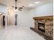 Living area with tile flooring, a stone fireplace, and an arched entry for easy flow into other spaces at 1663 Markel Dr. Dr, Winter Garden, FL 34787
