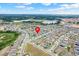 Wide aerial view of the community, pinpointing the property's location with a visual marker at 169 Jensen Dr, Groveland, FL 34736