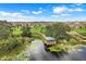 Aerial view of a community park featuring a gazebo, bridge, and lake, showcasing the natural beauty and recreational amenities at 169 Jensen Dr, Groveland, FL 34736