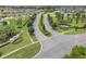 Stunning aerial view of the community's entrance with lush landscaping and well-maintained streets at 169 Jensen Dr, Groveland, FL 34736